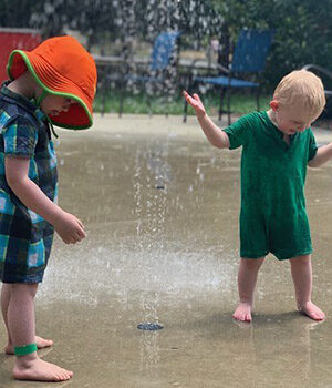 Tow children playing in fountain